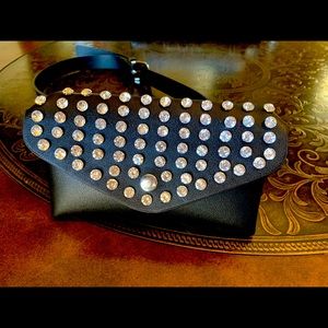 Black leather hip bag with rhinestones.